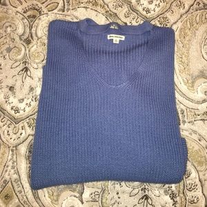 Long, loose blue sweater with cut out front